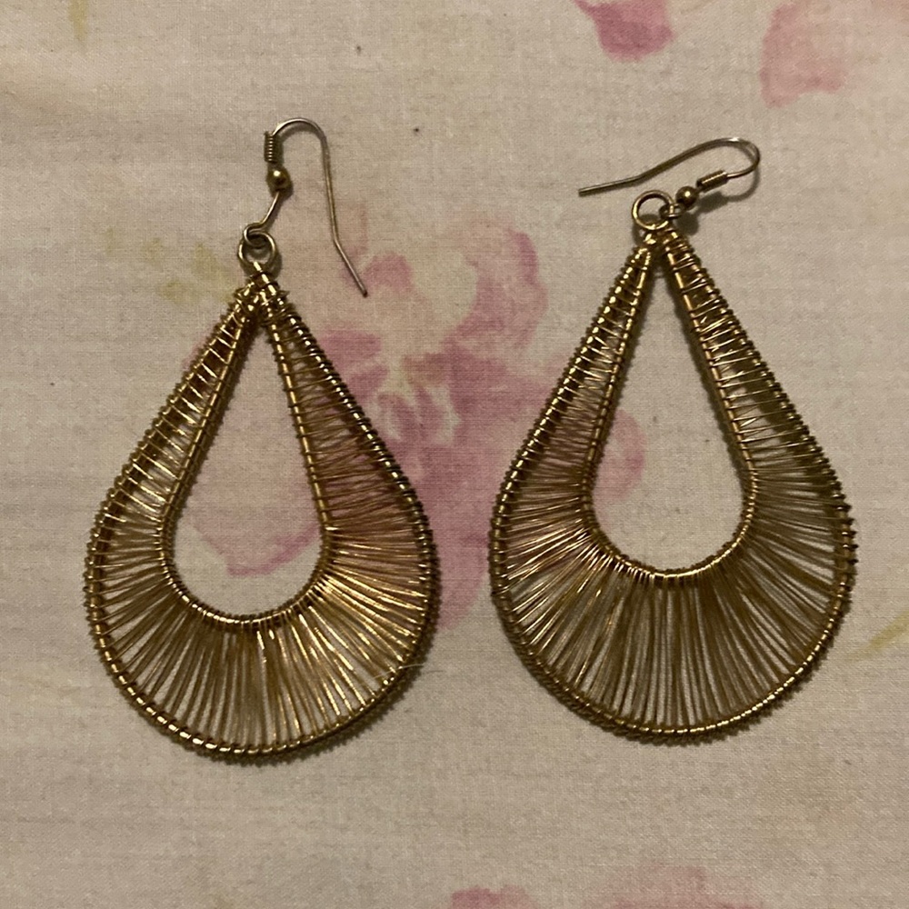 Gold colored earrings.